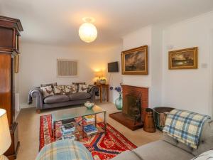 a living room with a couch and a fireplace at 1 Market Hill in Woodbridge