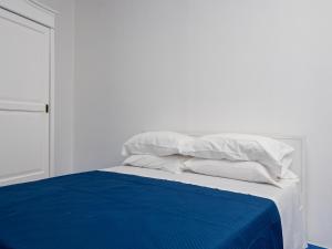 a white bed with blue sheets and white pillows at De Vivo Realty - Camilla House Positano in Positano