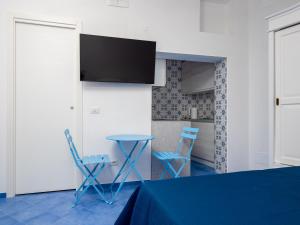 a room with a table and two chairs and a kitchen at De Vivo Realty - Camilla House Positano in Positano