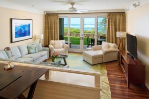 a living room with a couch and a tv at The Ritz-Carlton O'ahu, Turtle Bay in Kahuku
