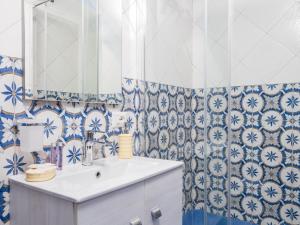 a bathroom with blue and white tiles and a sink at De Vivo Realty - Camilla House Positano in Positano +13 photos