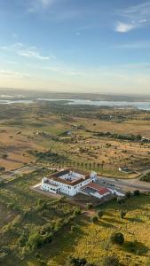 an aerial view of a large white building in a field at Convento da Orada - Monsaraz in Monsaraz