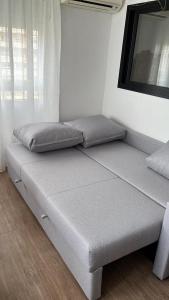 a bed sitting in a room next to a window at Sea City Torremolinos Beach in Torremolinos