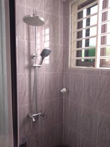 una ducha con cabezal de ducha en un baño en Serene 2 Bedroom House, en Ogbojo