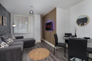 a living room with a couch and a table at Heart of the city 1 bed flat Queenshouse in Sheffield