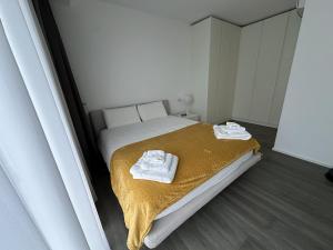 a small bedroom with a bed with towels on it at Garda Lake Luxury Life in Padenghe sul Garda