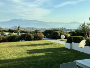 a garden with a view of mountains in the distance at Garda Lake Luxury Life in Padenghe sul Garda