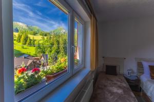 a bedroom with a large window with a view at Privát Marika in Ždiar