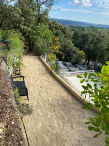 a bench sitting on top of a hill with trees at Mas du Rocher I Electio in Puget