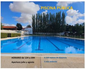 a large swimming pool with blue water at Apartamentos La Luna in La Solana