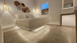 a bedroom with a bed and a mirror in it at Villa Chronos with private pool in Mýkonos City