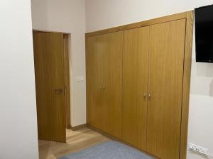a room with a large wooden cabinet and a television at Marinera in Luarca