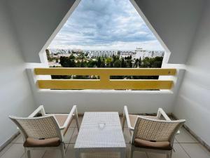 a balcony with a table and chairs and a window at Marhaba Royal Salem - Family Only in Sousse