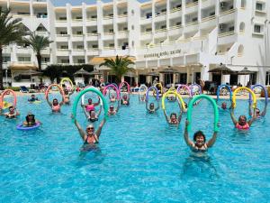 a group of children playing in the water at a swimming pool at Marhaba Royal Salem - Family Only in Sousse