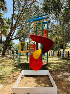 a playground with a slide in a park at Marhaba Royal Salem - Family Only in Sousse