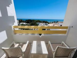 a balcony with chairs and a table and a view of the ocean at Marhaba Royal Salem - Family Only in Sousse
