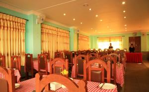 a conference room with chairs and tables and a man in the background at Hotel River Park in Pokhara
