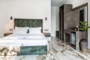 a bedroom with a large bed and a fireplace at B&B Lofts Thassos in Skala Rachoniou +53 photos
