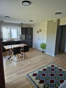 a kitchen and dining room with a table and chairs at Butas Ežero 30 in Plateliai