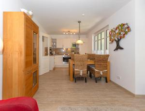 a kitchen and dining room with a table and chairs at Strandvilla Luv Lee Miramar in Rerik