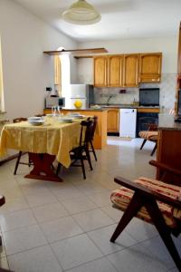 a kitchen with a table with a yellow table cloth at Casa della Genovina in Capodimonte