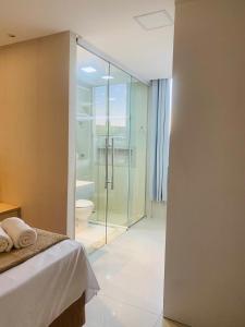 a bathroom with a glass shower and a toilet at Recanto Central Premium in Vitória da Conquista +25 photos