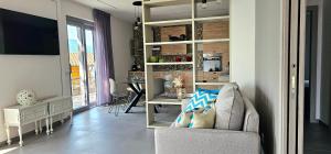 a living room with a chair and a dining room at Apartament 59 in Brenzone sul Garda