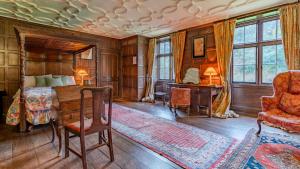 a bedroom with a bed and a desk and a chair at Kentchurch Court in Kentchurch