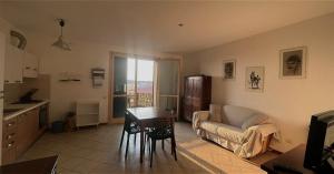 a living room with a couch and a table at Appartamento con posto auto in Viareggio