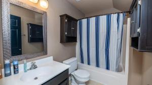 a bathroom with a sink and a toilet and a mirror at Charming, Spacious, Ideal 4 Groups Near Charleston in Charleston +18 photos