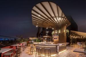 a restaurant with tables and chairs on a rooftop at night at Fairfield by Marriott Lima Miraflores in Lima