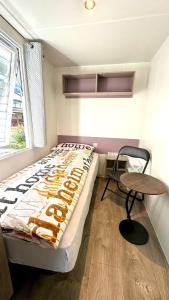 a bedroom with a bed and a table and a chair at Cottage 2 in Agarn