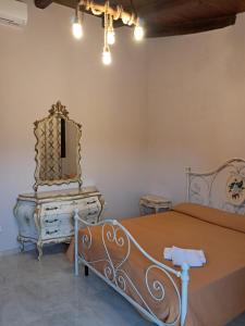 a bedroom with a bed and a dresser and a mirror at Le colline in Capena