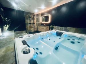 a large bath tub in a room with at nuit d exception avec jacuzzi in Bourg-de-Péage
