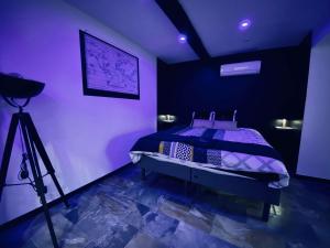a room with a bed with a camera and a tripod at nuit d exception avec jacuzzi in Bourg-de-Péage