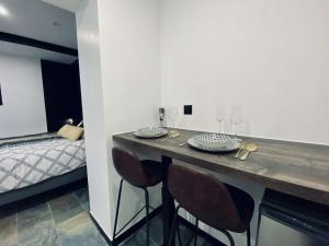 a room with a counter with chairs and a bed at nuit d exception avec jacuzzi in Bourg-de-Péage