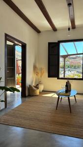 a living room with a table and a large window at Casa Moni con Vistas al Mar in Playa de Santiago