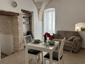 a living room with a table and a couch at Forno Mongelli 2.0 in Putignano +25 photos