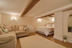 a living room with a bed and a couch at Blossom Lodge in Worcester