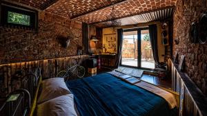 a bedroom with a bed and a brick wall at Panoramic Scenic View da Lusi - Pet Friendly in Cortandone +73 photos