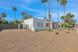 a white house with palm trees in the driveway at Sunlit Serenity in Tempe in Tempe