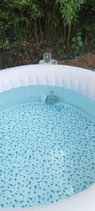 a bath tub with a clock on top of it at L escale jardin in Boussay