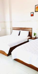 two beds sitting next to each other in a room at Anna homestay- Đông Tác, Tuy Hoà, Phú Yên in Ðông Tác (1) +6 photos