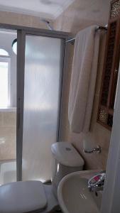 a bathroom with a toilet and a sink at Cinderella Malika in Al Bayāḑīyah