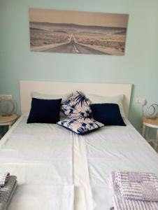 a bed with two pillows on top of it at Villa Leah Paralia Gerakinis in Gerakini