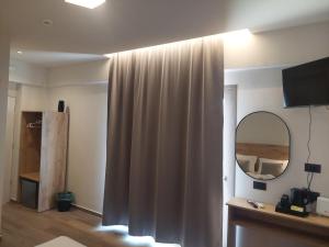 a living room with a curtain and a mirror at Lunar Hotel Modern Boutique in Hersonissos