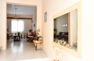 a living room with a mirror on the wall at Villa Konstantina in Tolo