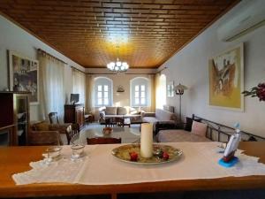 a living room with a table with a candle on it at MetaxiasAndMariasHouse in Leonidion +11 photos