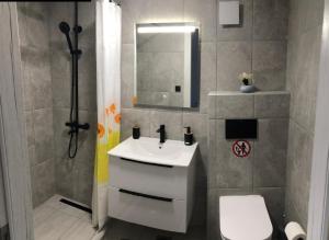 a bathroom with a sink and a toilet and a mirror at Villa Leah Paralia Gerakinis in Gerakini +30 photos