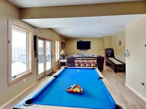 a living room with a pool table at Big and Boulder in McHenry